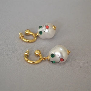 French vintage baroque pearl earrings with golden C-ring and quirky green-eyed smiley face