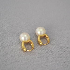 Eleganti orecchini a cerchio in ottone placcato oro con perle bianche su tessuto grigio