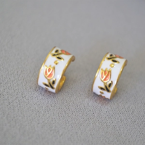Detail of vintage brass earrings featuring hand-painted enamel orange tulips
