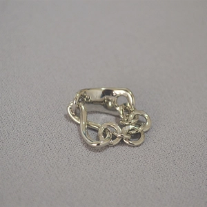 Detailed top view of silver chain link ring with industrial minimalist hammered texture