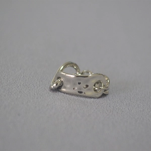 Close-up of hammered metal plate and chain link detail on a silver statement ring