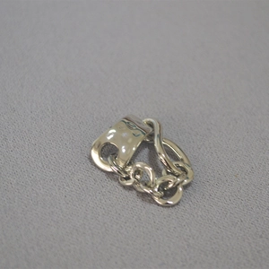 Close-up of irregular hammered texture silver ring with industrial chain design details