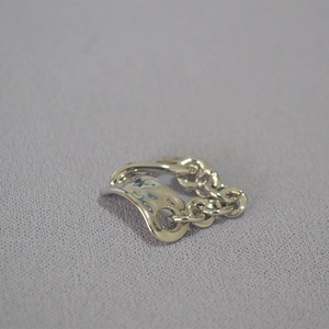 Detailed view of irregular hammered texture and soft chain link on this silver ring
