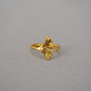 Detailed close-up of adjustable gold ginkgo leaf ring with realistic leaf texture