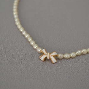 Elegant freshwater pearl necklace featuring a handcrafted white enamel butterfly pendant