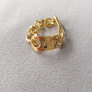 Detail of gold Cuban chain ring featuring a hollow bear silhouette on a rectangle plate