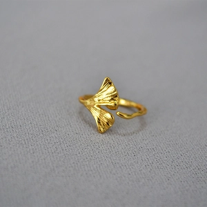 Macro shot of adjustable gold ginkgo leaf ring with detailed leaf vein textures