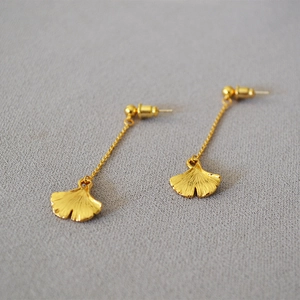 Elegant gold ginkgo leaf dangle earrings with delicate metal veins and minimalist chains