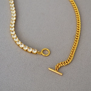 Asymmetric gold-plated necklace featuring tennis chain and cuban links with OT toggle clasp