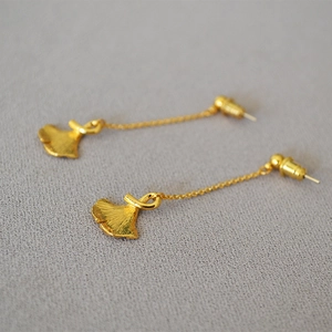 Elegant gold ginkgo leaf dangle earrings with long chains and textured finish for women