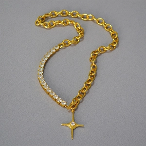 Detail of gold chain necklace with square cubic zirconia and North Star toggle clasp