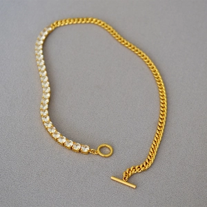 Detailed view of gold plated chain necklace with cubic zirconia and OT toggle clasp