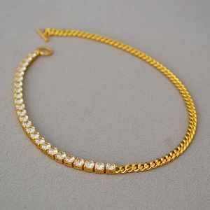 Detail of gold-plated chain necklace with cubic zirconia and OT toggle clasp