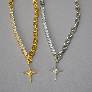 Detail of gold and silver chain necklaces featuring zircon accents and starburst pendants