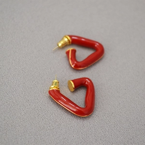 Geometric triangular earrings with gold-plated brass base and vibrant red enamel finish