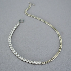 Detailed view of two-tone cuban chain and zircon stones with T-bar toggle clasp necklace