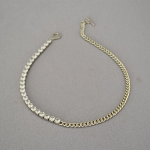 Detail of silver chain necklace with zircon tennis link and curb link T-bar closure