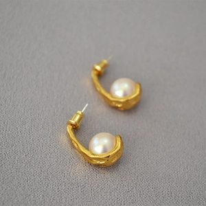 Retro matte gold hook earrings with white pearls and organic lava texture design