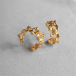 Detailed macro view of gold-plated irregular pleated C-shape flower hoop earrings