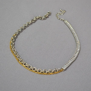 Detail of mixed-metal chain link necklace with rectangular cubic zirconia inlay