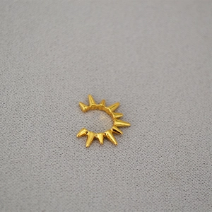 Minimalist gold punk spiked ear cuff with radiant sunburst rivet design for women