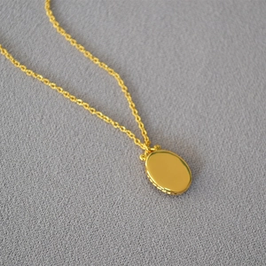 Elegant gold oval medallion necklace with vintage mirror design and North Star shell inlay