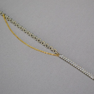 Detail of mixed-metal chain necklace featuring silver links and square zircon crystals