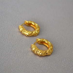 Minimalist thick golden hoop earrings with unique lava texture and molten metal surface