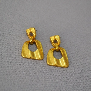 Vintage irregular geometric brass earrings with matte gold plating and a unique wave shape