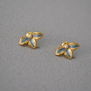 Elegant floral stud earrings featuring blue enamel petals and a small pearl center
