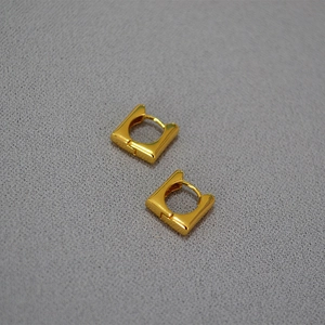 Boucles d'oreilles créoles carrées minimalistes plaquées or sur une surface grise texturée