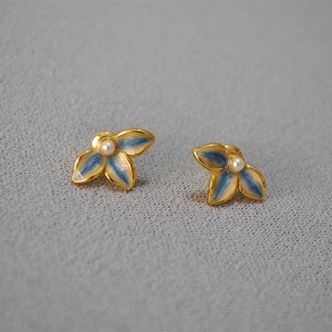 Elegant gold leaf earrings with blue enamel petals and a central white pearl detail