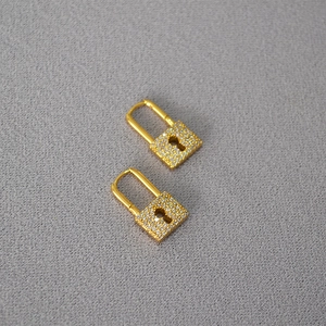 Detail of gold-plated padlock earrings with micro-paved sparkling cubic zirconia stones