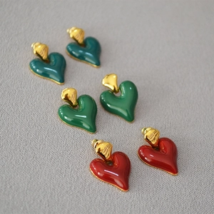 Detail of vintage heart enamel earrings in dark green, light green and burgundy red