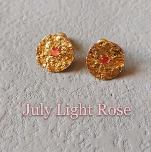 Detail of July Rose Pink birthstone stud earring with hammered gold texture and silver pin