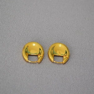 Macro view of French style oval gold plated hoop earrings with hinge closure detail