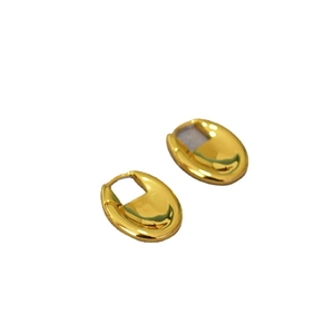 Polished gold-plated oval hoop earrings with a minimalist mirror finish in a sleek design