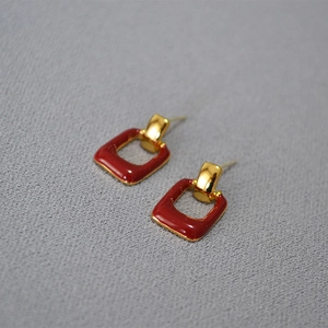 Detail of red enamel square drop earrings with 925 silver needle and gold plating