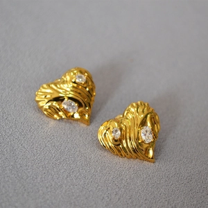 Retro golden heart earrings with wavy metal texture and sparkling zircon stones