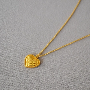 French vintage quilted heart pendant necklace in gold finish shown from a 45-degree angle