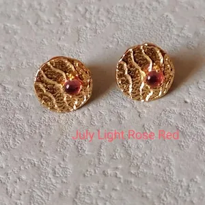 Detailed view of gold hammered earrings featuring a July Light Rose Red birthstone gem