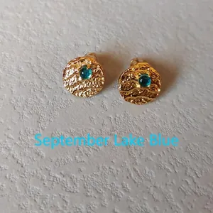 Detail of September Lake Blue gemstone earring with textured gold-tone metal finish
