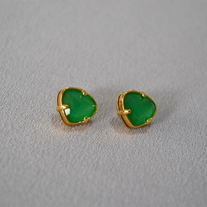 Detail view of heart-shaped green jade earrings with gold plated prong settings
