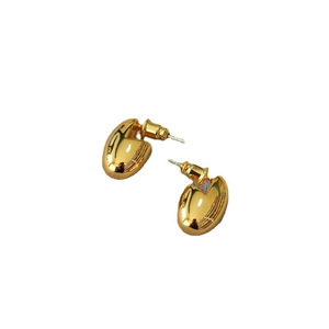 Minimalist gold-plated bean-shaped stud earrings with high-polish finish on white background