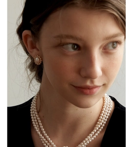 Model wearing multi-layer pearl necklace and matching oval zircon stud earrings