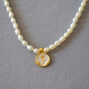 French vintage freshwater pearl necklace with a white enamel rose gold coin pendant