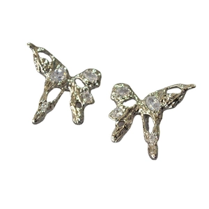 Lava style silver butterfly stud earrings with sparkling cubic zirconia on white background