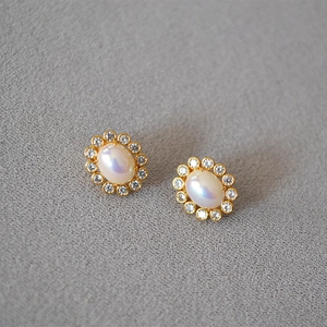 Oval shimmer pearl earrings with gold halo cubic zirconia wreath for women