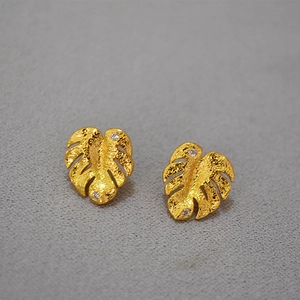 Golden monstera leaf earrings with sparkling zircon crystals for a tropical resort style