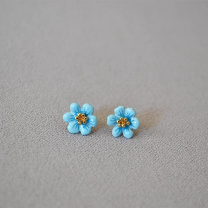 Elegant 925 silver stud earrings with blue enamel camellia flower design and golden accents